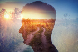 Silhouette of a man with a nature path in the background