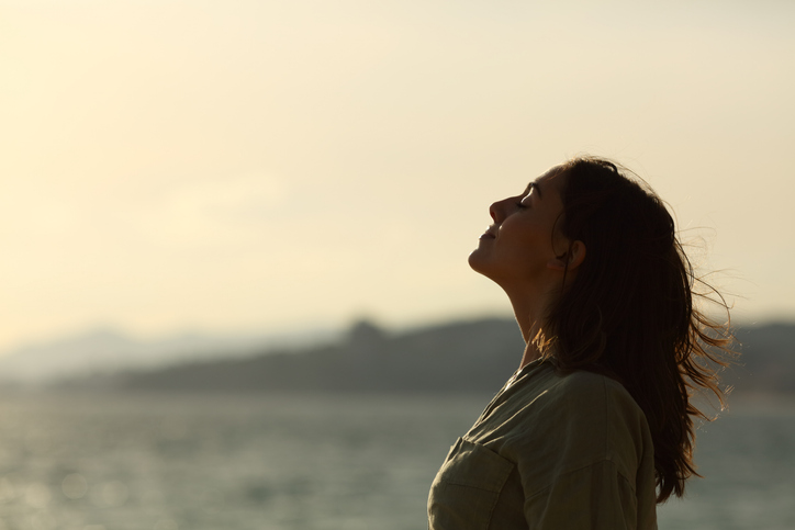 Woman looking up in relief as she achieves emotional sobriety