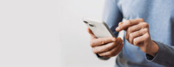 Man holding a cell phone about to dial a recovery hotline number