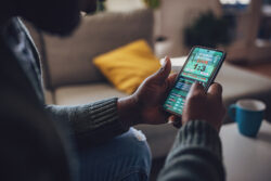 Gentlemen suffering from problem gambling placing a wager on his mobile app